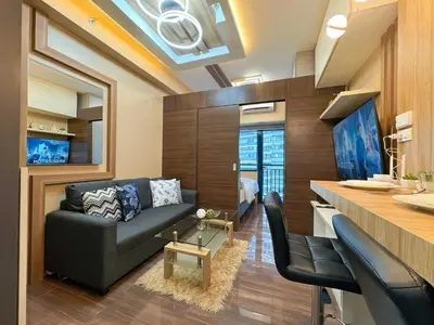 a living room with a couch and a table at 1BR Makati, Air Residences M005 in Manila