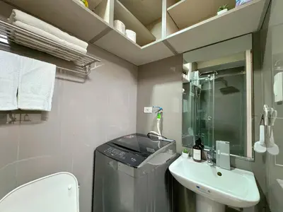 a small bathroom with a sink and a toilet at 1BR Makati, Air Residences M005 in Manila
