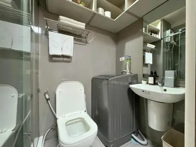 a bathroom with a toilet and a sink at 1BR Makati, Air Residences M005 in Manila