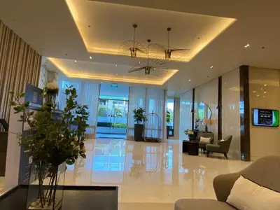 a lobby with a couch and chairs and a table at Cozy Blossom near NAIA in Manila