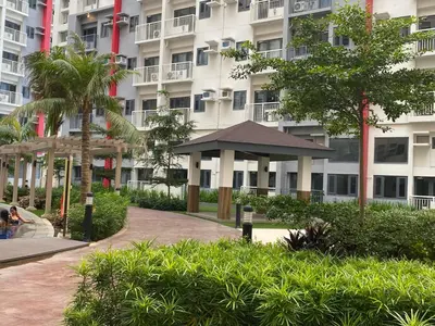 a building with a gazebo in front of it at Cozy Blossom near NAIA in Manila