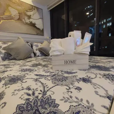a box of towels and towels on a bed at Spacious 1BR Milano by Versace in Makati in Manila