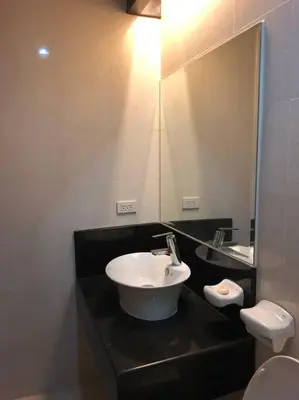 a bathroom with a sink and a mirror at 1-Bedroom condo with pool across NAIA Terminal 3 in Manila