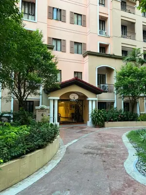 a large pink building with a building at 1-Bedroom condo with pool across NAIA Terminal 3 in Manila