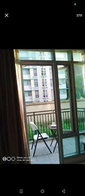 a balcony with a table and a chair on a balcony at cozy Avah condotel newport in Manila