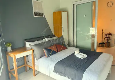 a bedroom with a bed with a nightstand and a bed sidx sidx at Cobblestone City Stays - SM Mezza 1 Residences in Manila