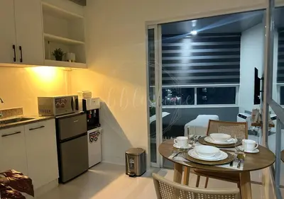 a kitchen and dining room with a table and chairs at Cobblestone City Stays - SM Mezza 1 Residences in Manila