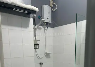 a shower in a bathroom with a shower head at Cobblestone City Stays - SM Mezza 1 Residences in Manila