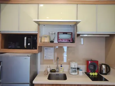 a kitchen with a sink and a microwave at Modern 1BD in Ortigas, WiFi ,Netflix ,Pool ,Gym in Manila