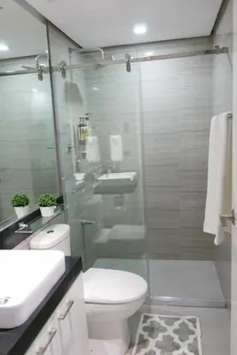 a bathroom with a toilet and a sink and a shower at Modern 1BD in Ortigas, WiFi ,Netflix ,Pool ,Gym in Manila