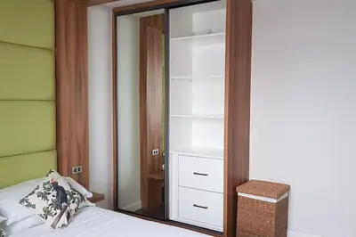 a bedroom with a mirror next to a bed at Modern 1BD in Ortigas, WiFi ,Netflix ,Pool ,Gym in Manila