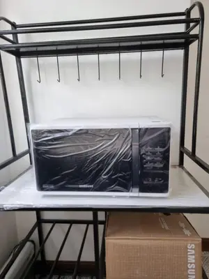 a microwave sitting on a shelf in a refrigerator at 1 MARY's STAYCATION Condo Type with Balcony 2 person in Tanza