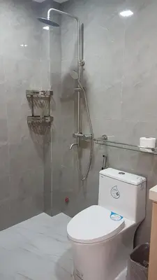 a bathroom with a toilet and a glass shower at 1 MARY's STAYCATION Condo Type with Balcony 2 person in Tanza