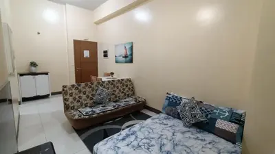 a living room with a couch and a bed at 1 bedroom Condotel in front of terminal 3 Airport in Manila