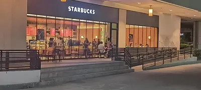 a store front of a store with tables and chairs at 1 bedroom Condotel in front of terminal 3 Airport in Manila