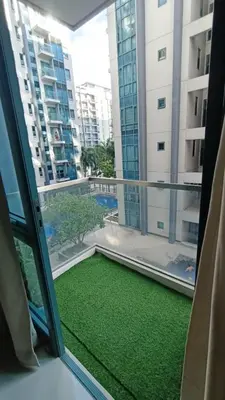 a view from a window of a balcony with green grass at 1 bedroom Condotel in front of terminal 3 Airport in Manila