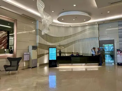 a lobby with people standing at a counter in a building at Belle 4621 by TPS in Manila