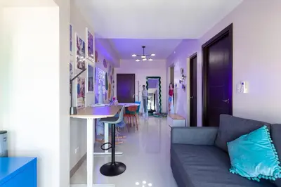 a living room with a couch and a table at Korea In The City Staycation with Pool, Gym and More in Manila