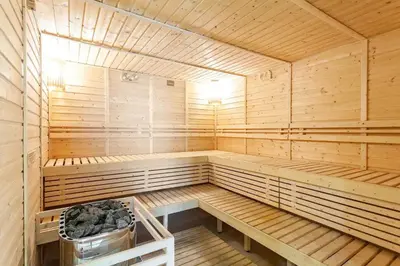 a wooden sauna with a bench in the middle at The Peaky Blinder s Crib with Gym, Pool, Sauna More in Manila
