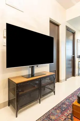 a flat screen tv sitting on top of a table at The Peaky Blinder s Crib with Gym, Pool, Sauna More in Manila