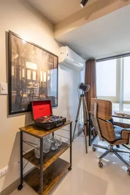 a room with a desk with a laptop and a chair at The Peaky Blinder s Crib with Gym, Pool, Sauna More in Manila