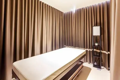 a hospital room with a bed and curtains at The Peaky Blinder s Crib with Gym, Pool, Sauna More in Manila