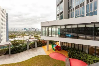 an apartment balcony with a view of the city at The Peaky Blinder s Crib with Gym, Pool, Sauna More in Manila