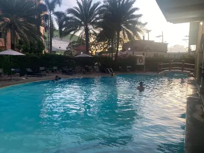 a group of people swimming in a swimming pool at B & M Condo near NAIA Airport and SM Mall in Manila