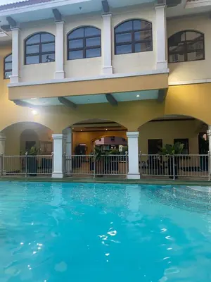 a swimming pool in front of a hotel at B & M Condo near NAIA Airport and SM Mall in Manila
