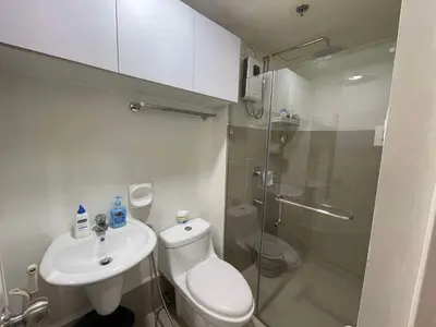 a bathroom with a toilet and a sink and a shower at B & M Condo near NAIA Airport and SM Mall in Manila