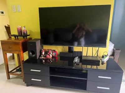 a flat screen tv sitting on a entertainment center at vevilyn condotel in Manila