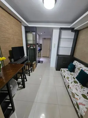 a living room with a couch and a table at Moa Staycation at Sea Residences Mingchie place in Manila