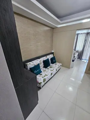 a room with a bed with blue pillows on it at Moa Staycation at Sea Residences Mingchie place in Manila