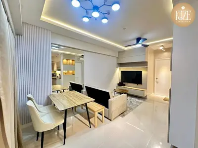 a dining room with a table and chairs and a television at Kize Staycation in Manila