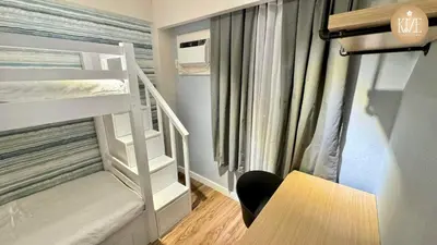a small room with a bunk bed and a desk at Kize Staycation in Manila