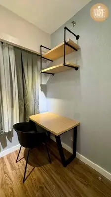 a table and a chair in a room at Kize Staycation in Manila