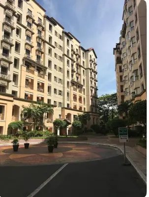an empty street in front of a large building at Montecito unit near airport in Manila