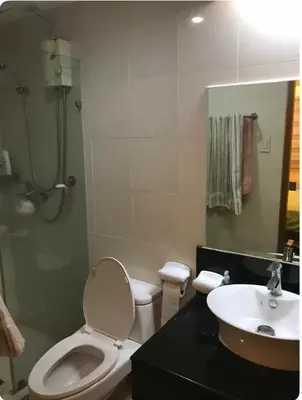 a bathroom with a toilet and a sink at Montecito unit near airport in Manila