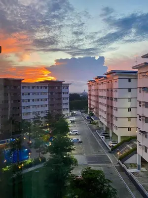 a city street with tall buildings and a sunset at Glade Suite in Trece Martires