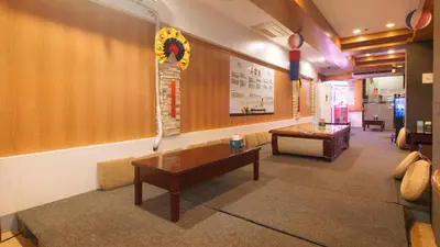 a waiting room with a table and a bench at RedDoorz Premium at JjimJBang Hotel Spa in Manila