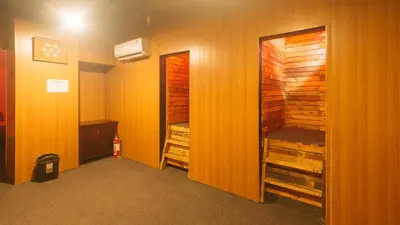 a room with wooden walls and a room with a closet at RedDoorz Premium at JjimJBang Hotel Spa in Manila