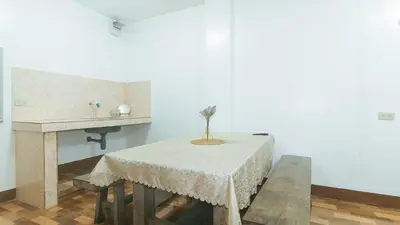 a white room with a table and a sink at RedDoorz at Joels Apartelle in Calaboso