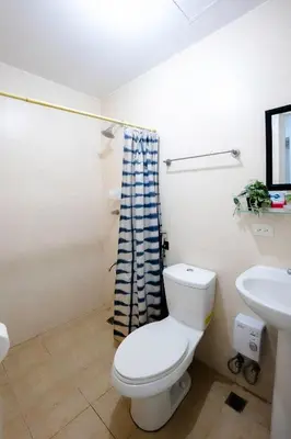 a bathroom with a toilet and a sink at Premium 1BR unit at The Avant in Manila
