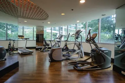a gym with several treadmills and elliptical machines at Premium 1BR unit at The Avant in Manila