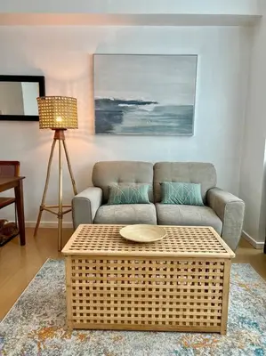 a living room with a couch and a coffee table at Charming 3-BR Condo in BGC in Manila