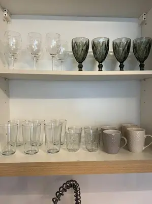 a row of wine glasses sitting on a shelf at Contemporary Studio at Avant BGC in Manila