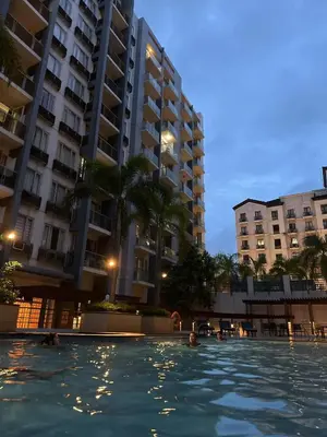 a swimming pool in front of some tall buildings at ONE PALM TREE VILLAS-Hyuna Place, Acros NAIA T3 in Manila