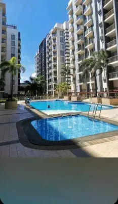 a large swimming pool in front of some buildings at ONE PALM TREE VILLAS-Hyuna Place, Acros NAIA T3 in Manila