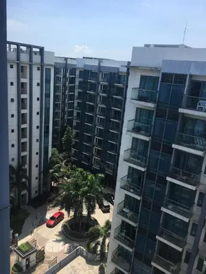 an apartment building with a palm tree in front of it at ONE PALM TREE VILLAS-Hyuna Place, Acros NAIA T3 in Manila