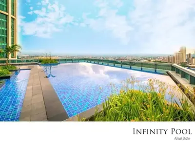 an infinity pool on the roof of a building at Executive 1 Bedroom with Pool Sauna Gym and More in Manila